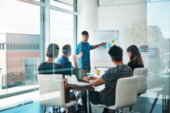Corporate team discussing strategic market entry and neurotech business expansion in a modern office conference room.