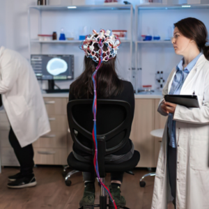 Clinical researcher conducting advanced EEG brain mapping and neuro-monitoring assessment with head cap headset